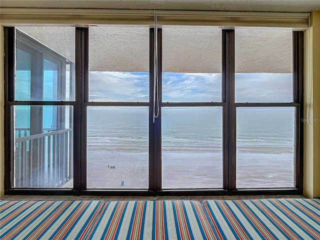 doorway to outside featuring a water view and dark carpet