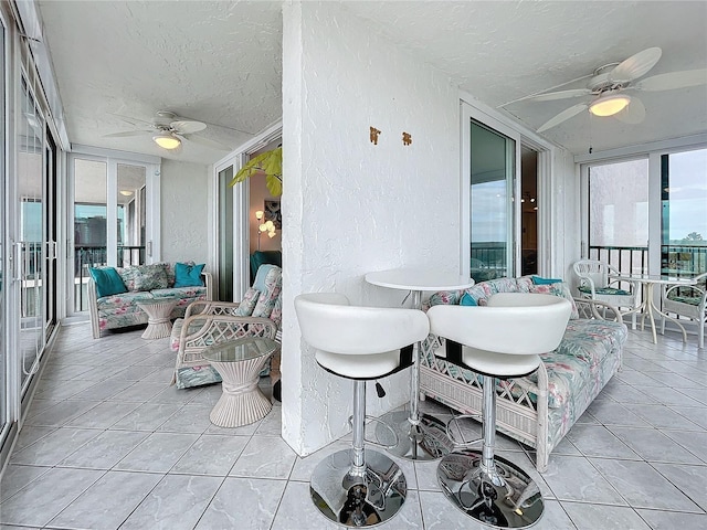 sunroom featuring ceiling fan