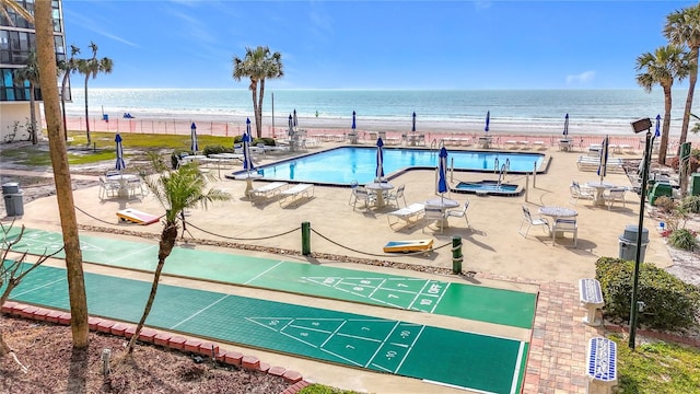 view of property's community featuring a water view and a view of the beach