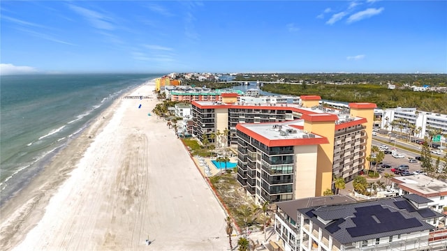 drone / aerial view with a water view and a beach view