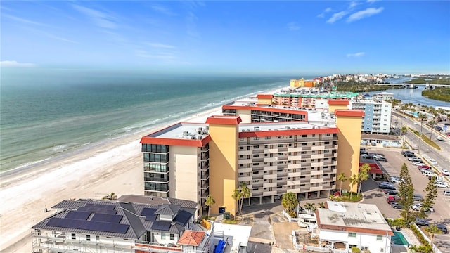 birds eye view of property featuring a beach view and a water view