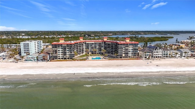 drone / aerial view featuring a water view and a beach view