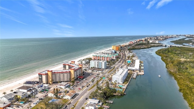 birds eye view of property featuring a beach view and a water view