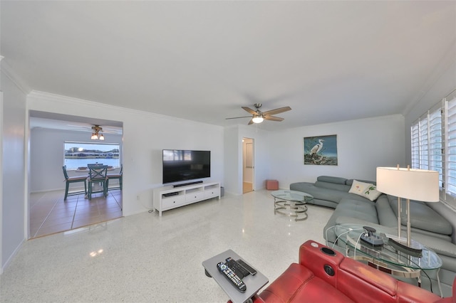 living room with ornamental molding, ceiling fan, and a healthy amount of sunlight