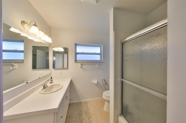 bathroom with vanity, tile patterned flooring, a shower with door, and toilet