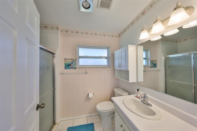 bathroom with toilet, walk in shower, tile patterned flooring, and vanity