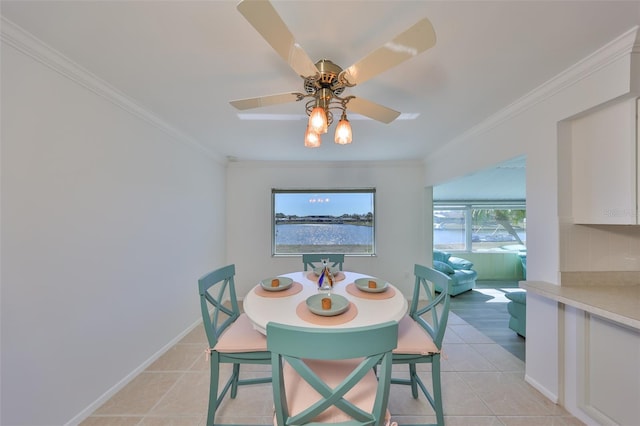 dining space featuring crown molding, light tile patterned flooring, and ceiling fan