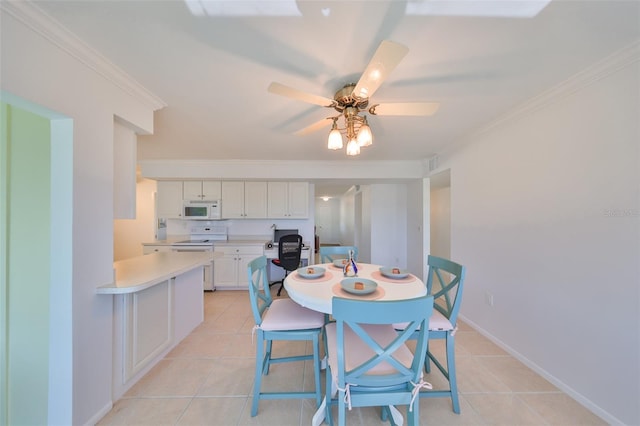 dining area with light tile patterned flooring, ceiling fan, and ornamental molding