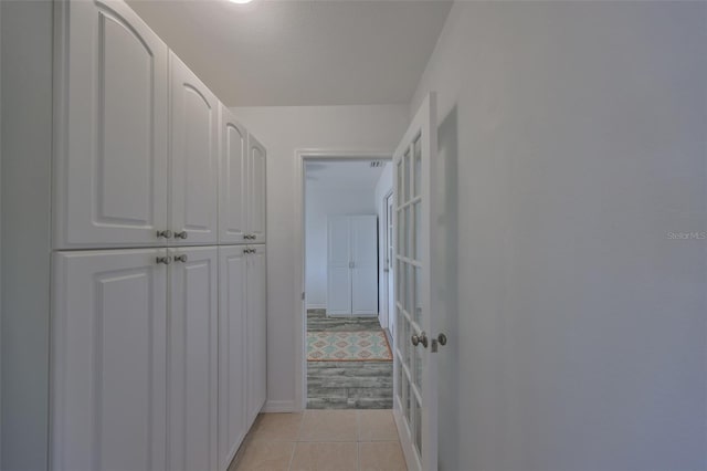 hallway with light tile patterned floors