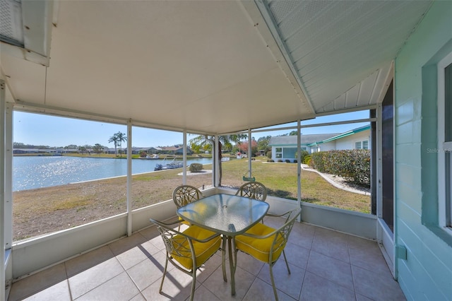 unfurnished sunroom featuring a water view