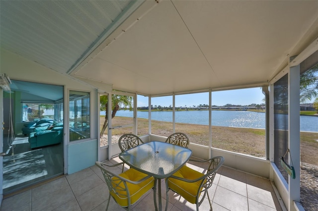 sunroom / solarium with a water view