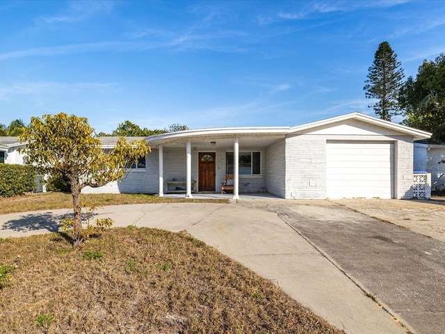 ranch-style house with a garage and covered porch