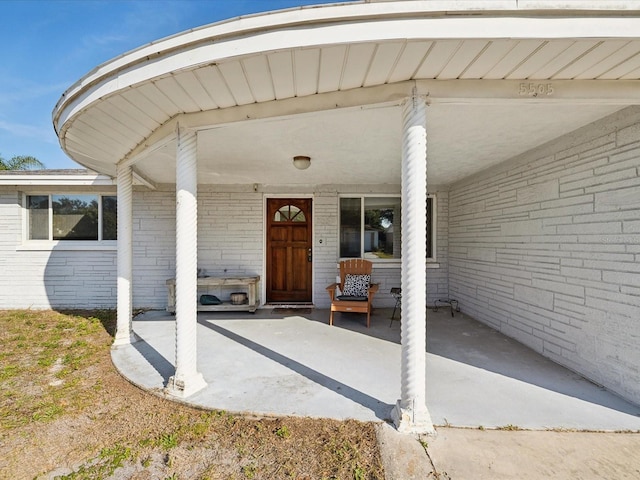 doorway to property with a carport