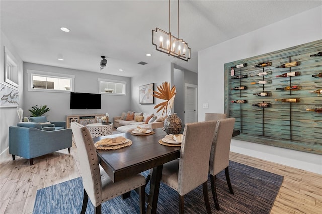 dining room featuring an inviting chandelier and light hardwood / wood-style floors