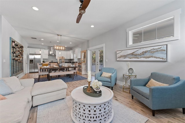 living room featuring light wood-type flooring and french doors