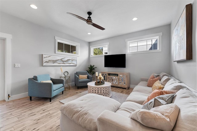 living room with ceiling fan and light wood-type flooring