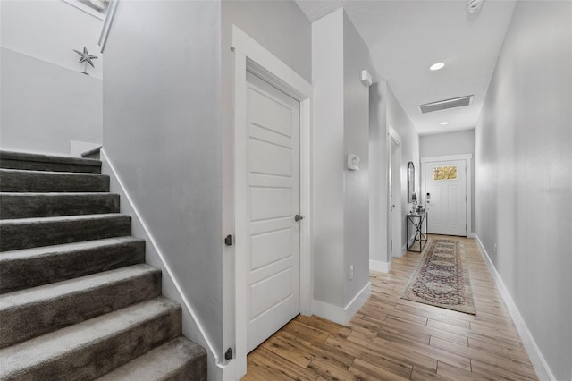 hallway with hardwood / wood-style flooring