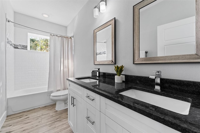 full bathroom with shower / tub combo with curtain, vanity, wood-type flooring, and toilet