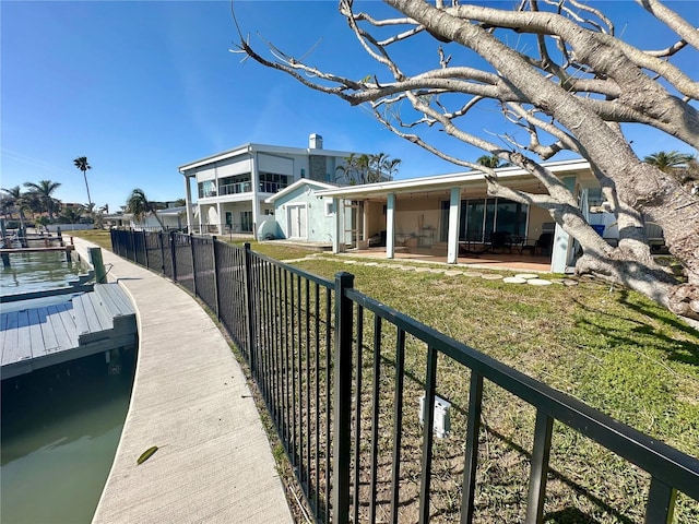 rear view of property featuring a yard and a patio area