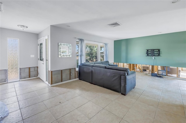 unfurnished living room with light tile patterned floors