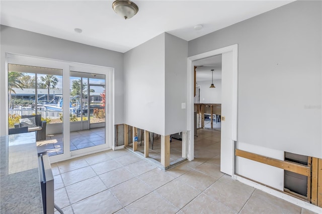 doorway to outside featuring tile patterned flooring