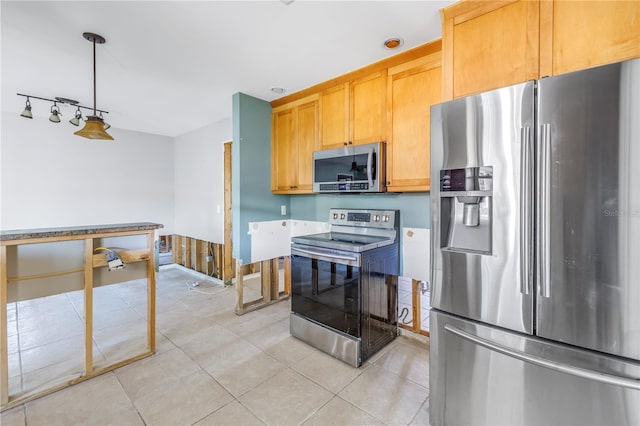 kitchen with stainless steel appliances, pendant lighting, light brown cabinets, and light tile patterned floors