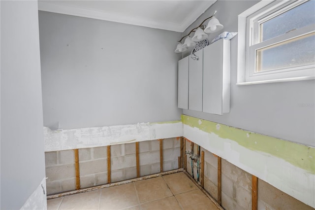 bathroom featuring tile patterned flooring and crown molding