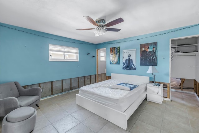 bedroom with a walk in closet, a closet, ceiling fan, and light tile patterned flooring