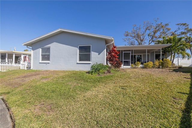 back of property featuring a lawn