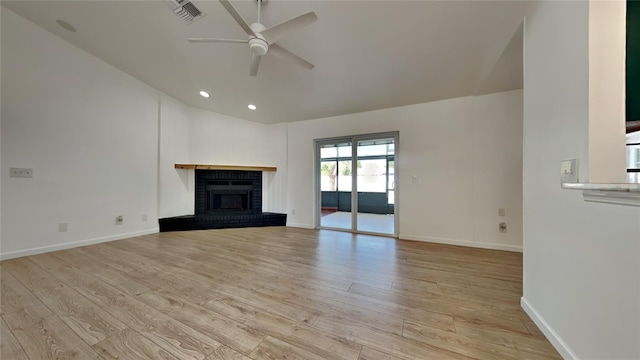 unfurnished living room with ceiling fan, a fireplace, and light wood-type flooring