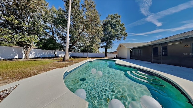 view of pool with a lawn and a patio area