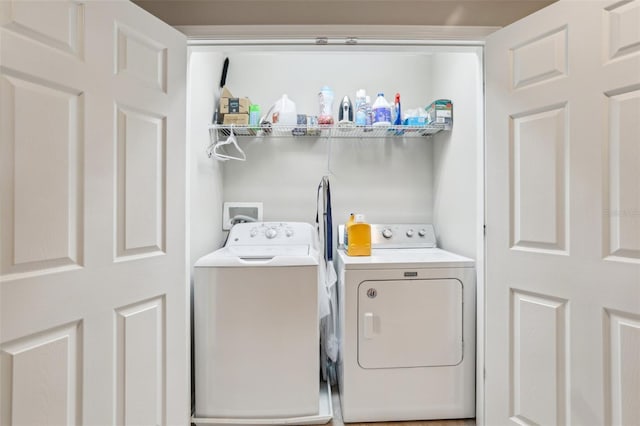 clothes washing area with washing machine and clothes dryer