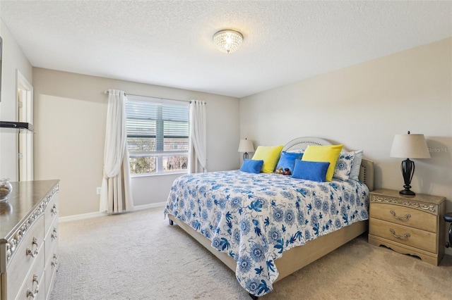 bedroom with light carpet and a textured ceiling