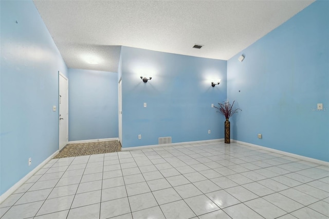 unfurnished room with a textured ceiling