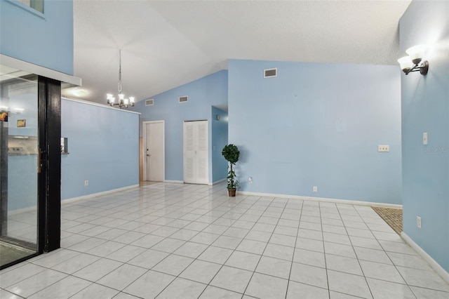 unfurnished room with light tile patterned floors, a notable chandelier, and high vaulted ceiling