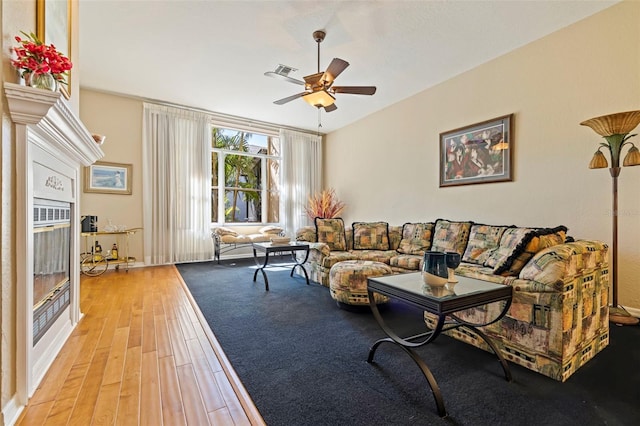 living room featuring ceiling fan and light wood-type flooring