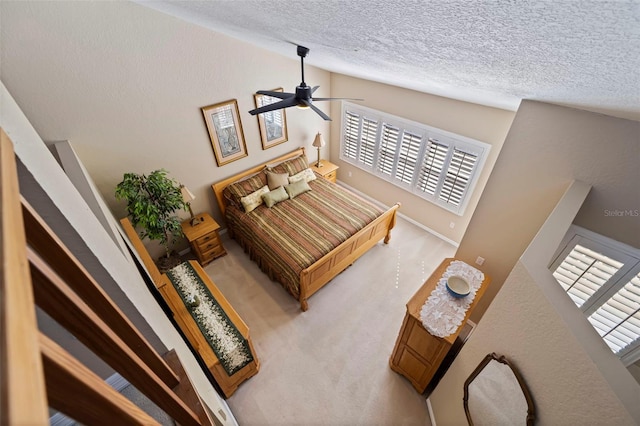 carpeted bedroom featuring vaulted ceiling, ceiling fan, and a textured ceiling