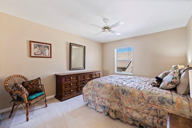 carpeted bedroom with ceiling fan and a textured ceiling