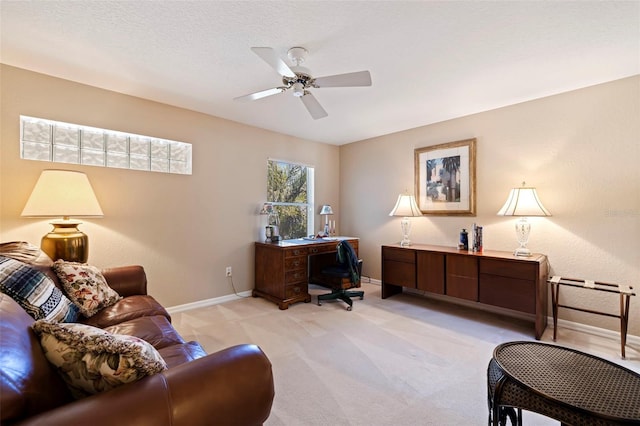 carpeted office space with ceiling fan and a textured ceiling