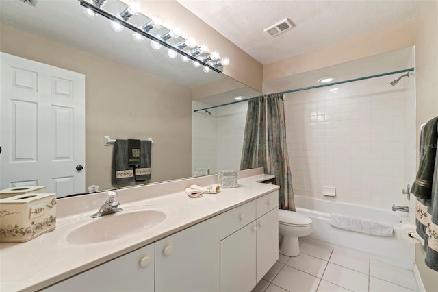 full bathroom with vanity, toilet, shower / bath combo, tile patterned floors, and a textured ceiling