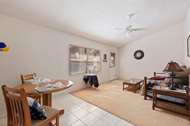 living room with lofted ceiling, ceiling fan, light colored carpet, and a textured ceiling