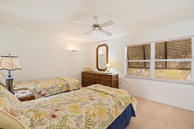 carpeted bedroom with ceiling fan and a textured ceiling