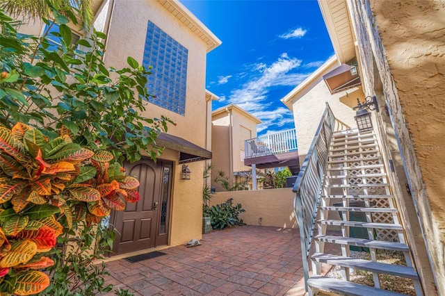 view of patio / terrace with fence and stairway