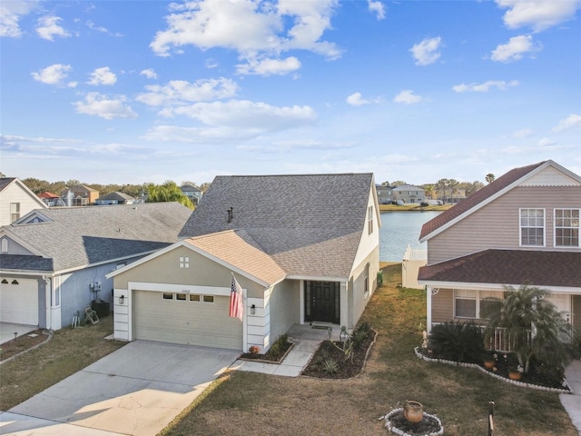 view of front of property with a water view, a garage, and a front lawn