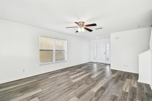 spare room featuring dark wood-type flooring and ceiling fan