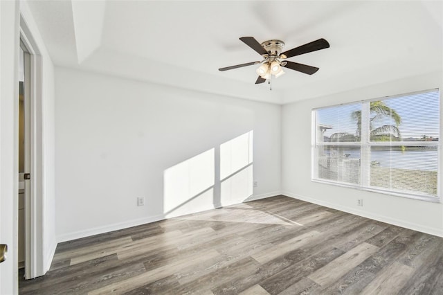 spare room featuring ceiling fan and dark hardwood / wood-style flooring