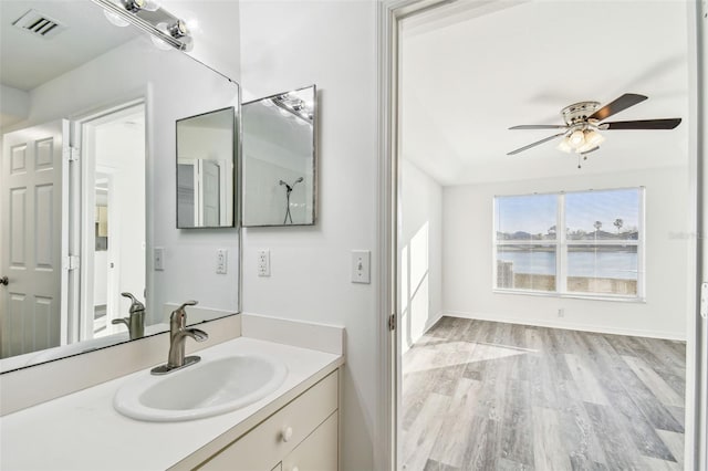 bathroom with ceiling fan, vanity, and hardwood / wood-style floors