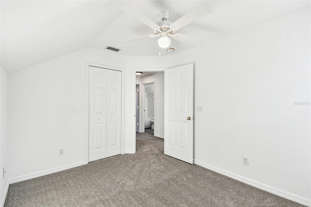 unfurnished bedroom featuring lofted ceiling, carpet floors, a closet, and ceiling fan