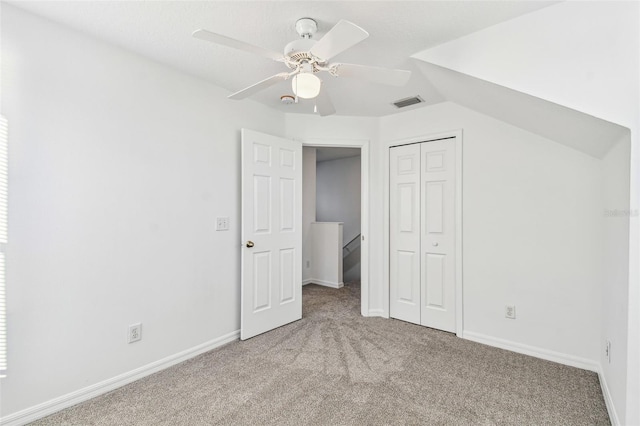 unfurnished bedroom with light carpet, a closet, and ceiling fan