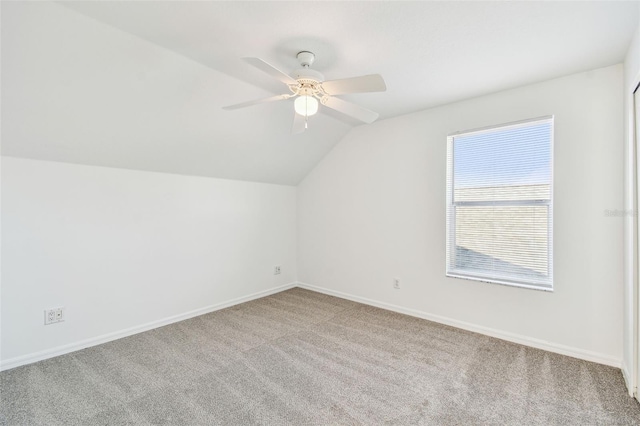 additional living space featuring ceiling fan, light colored carpet, and lofted ceiling